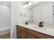 Bright bathroom featuring double sink vanity with quartz countertops and modern fixtures at 8686 Pennycress Dr, Littleton, CO 80125