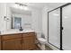 Bathroom features white tile shower, single sink vanity, and modern fixtures at 8686 Pennycress Dr, Littleton, CO 80125