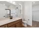 Well-lit bathroom features vanity with quartz countertop, wood cabinetry, and glass shower at 8686 Pennycress Dr, Littleton, CO 80125