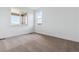 Spacious carpeted bedroom with natural light from windows at 8686 Pennycress Dr, Littleton, CO 80125