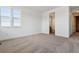 Inviting bedroom featuring soft carpeting, natural light, and ensuite bathroom at 8686 Pennycress Dr, Littleton, CO 80125