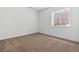 Bedroom features carpeted floor, white walls, and a window at 8686 Pennycress Dr, Littleton, CO 80125