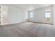 Spacious carpeted bedroom with ensuite bathroom, patio doors and plenty of natural light at 8686 Pennycress Dr, Littleton, CO 80125