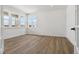 Sunlit bedroom with wood floors, recessed lighting, white walls and trim, and numerous windows at 8686 Pennycress Dr, Littleton, CO 80125