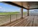 Large deck with wood floors and stone columns offers beautiful views at 8686 Pennycress Dr, Littleton, CO 80125