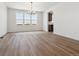Dining room with wood floors, modern chandelier, white walls, and large windows overlooking the landscape at 8686 Pennycress Dr, Littleton, CO 80125