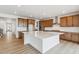 Bright kitchen boasts an expansive island, white countertops, and modern wood cabinetry at 8686 Pennycress Dr, Littleton, CO 80125