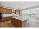 A spacious kitchen with wood cabinets, stainless steel appliances, and bright, natural light at 8686 Pennycress Dr, Littleton, CO 80125