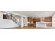 Open floorplan featuring a modern kitchen with stainless appliances and wood floors at 8686 Pennycress Dr, Littleton, CO 80125