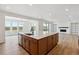Open concept kitchen with a large center island, stainless steel appliances, and an adjacent living room at 8686 Pennycress Dr, Littleton, CO 80125