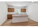Kitchenette features wood cabinets, white countertops, stainless steel sink, and vinyl wood flooring at 8686 Pennycress Dr, Littleton, CO 80125