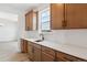 Kitchen with light countertops, wood cabinets, and stainless steel appliances, filled with natural light at 8686 Pennycress Dr, Littleton, CO 80125