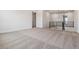 An open living room with neutral walls, carpet flooring, and modern railings at 8686 Pennycress Dr, Littleton, CO 80125