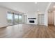 Living room with wood floors, a modern fireplace, and sliding glass doors to the deck at 8686 Pennycress Dr, Littleton, CO 80125