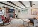 Comfortable basement featuring a brick fireplace, built-in shelving, and cozy seating at 8898 W Harvard Pl, Lakewood, CO 80227