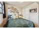 Bedroom with decorative woven baskets on wall, green bedding and closet at 8898 W Harvard Pl, Lakewood, CO 80227