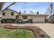 Charming two-story home with a well-manicured front yard, covered front porch, and an attached two car garage at 8898 W Harvard Pl, Lakewood, CO 80227