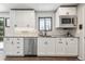 Well-lit kitchen featuring stainless steel appliances, white cabinets, and stylish countertops for a modern look at 8898 W Harvard Pl, Lakewood, CO 80227