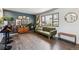 Stylish living room featuring a blue accent wall, wood floors, and large windows that bring in natural light at 8898 W Harvard Pl, Lakewood, CO 80227