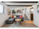 Basement living room with a modern sectional couch and view of the dining area at 8898 W Harvard Pl, Lakewood, CO 80227