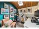 Inviting home office with natural light from a skylight, a cozy chair, and wood-look floors at 8898 W Harvard Pl, Lakewood, CO 80227