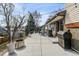 Concrete patio featuring a barbecue, dining furniture, string lights, and partial view of a backyard at 8898 W Harvard Pl, Lakewood, CO 80227