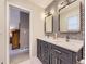 Elegant bathroom showcasing double sinks, decorative wall, and herringbone tile floor at 5456 E Briarwood Pl, Centennial, CO 80122