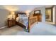 Comfortable bedroom featuring wood furniture, patterned bedding, and carpet at 5456 E Briarwood Pl, Centennial, CO 80122