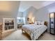 Bright bedroom with a sloped ceiling, cozy bed, and built-in bookcase at 5456 E Briarwood Pl, Centennial, CO 80122