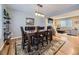 Elegant dining area showcasing a wooden table, leather chairs, and an open layout to the living room at 5456 E Briarwood Pl, Centennial, CO 80122