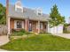 Charming brick home with a welcoming front porch, dormer windows, and a well-maintained lawn at 5456 E Briarwood Pl, Centennial, CO 80122