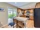 Functional kitchen featuring wooden cabinets, stainless appliances, and access to outdoor seating at 5456 E Briarwood Pl, Centennial, CO 80122