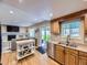 Open kitchen showcasing hardwood floors, stainless steel appliances, and seamless connection to the living space at 5456 E Briarwood Pl, Centennial, CO 80122