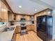 Well-lit kitchen featuring wooden cabinets, stainless steel appliances, and hardwood floors at 5456 E Briarwood Pl, Centennial, CO 80122