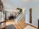 Inviting living room featuring hardwood floors, a dining area, and a staircase at 5456 E Briarwood Pl, Centennial, CO 80122