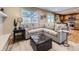 Cozy living room featuring a plush sectional sofa, stylish ottoman, and modern decor at 5456 E Briarwood Pl, Centennial, CO 80122