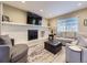Inviting living room featuring a fireplace, comfortable seating, and a relaxing ambiance at 5456 E Briarwood Pl, Centennial, CO 80122