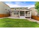 Well-manicured backyard with grass, garden and raised deck with stairs and pillars at 19722 W 59Th Ave, Golden, CO 80403