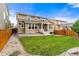 Landscaped backyard with lawn, rocks, garden and raised deck with pillars at 19722 W 59Th Ave, Golden, CO 80403