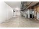 Unfinished basement with concrete floor, white wrapped walls and visible ductwork at 19722 W 59Th Ave, Golden, CO 80403