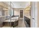 Modern bathroom with large soaking tub, glass shower and granite vanity with dark cabinets at 19722 W 59Th Ave, Golden, CO 80403