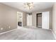 Bedroom with neutral paint, plush carpeting, and ceiling fan, plus view into bathroom at 19722 W 59Th Ave, Golden, CO 80403