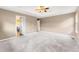 Spacious primary bedroom with three entries and soft carpeting features neutral paint and tray ceiling at 19722 W 59Th Ave, Golden, CO 80403