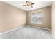 Cozy bedroom featuring a ceiling fan, carpet floors, and natural light, providing a relaxing retreat at 19722 W 59Th Ave, Golden, CO 80403