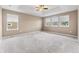 Spacious bedroom with plush carpeting features three large windows and a ceiling fan at 19722 W 59Th Ave, Golden, CO 80403