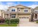 Two-story home with a tan exterior, two car garage, and well-maintained landscaping at 19722 W 59Th Ave, Golden, CO 80403