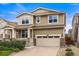Charming two-story home featuring a front porch, two-car garage and manicured landscaping at 19722 W 59Th Ave, Golden, CO 80403
