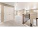 Bright upstairs hallway features neutral walls, carpet, and white trim with natural light at 19722 W 59Th Ave, Golden, CO 80403