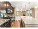 Open kitchen with granite countertops, stainless steel appliances, and hardwood floors overlooking the living area at 19722 W 59Th Ave, Golden, CO 80403