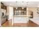 Modern kitchen features a large island, stainless steel appliances, pendant lighting and hardwood floors at 19722 W 59Th Ave, Golden, CO 80403